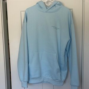 Light Blue Pullover Hoodie with Subtle Chest Text